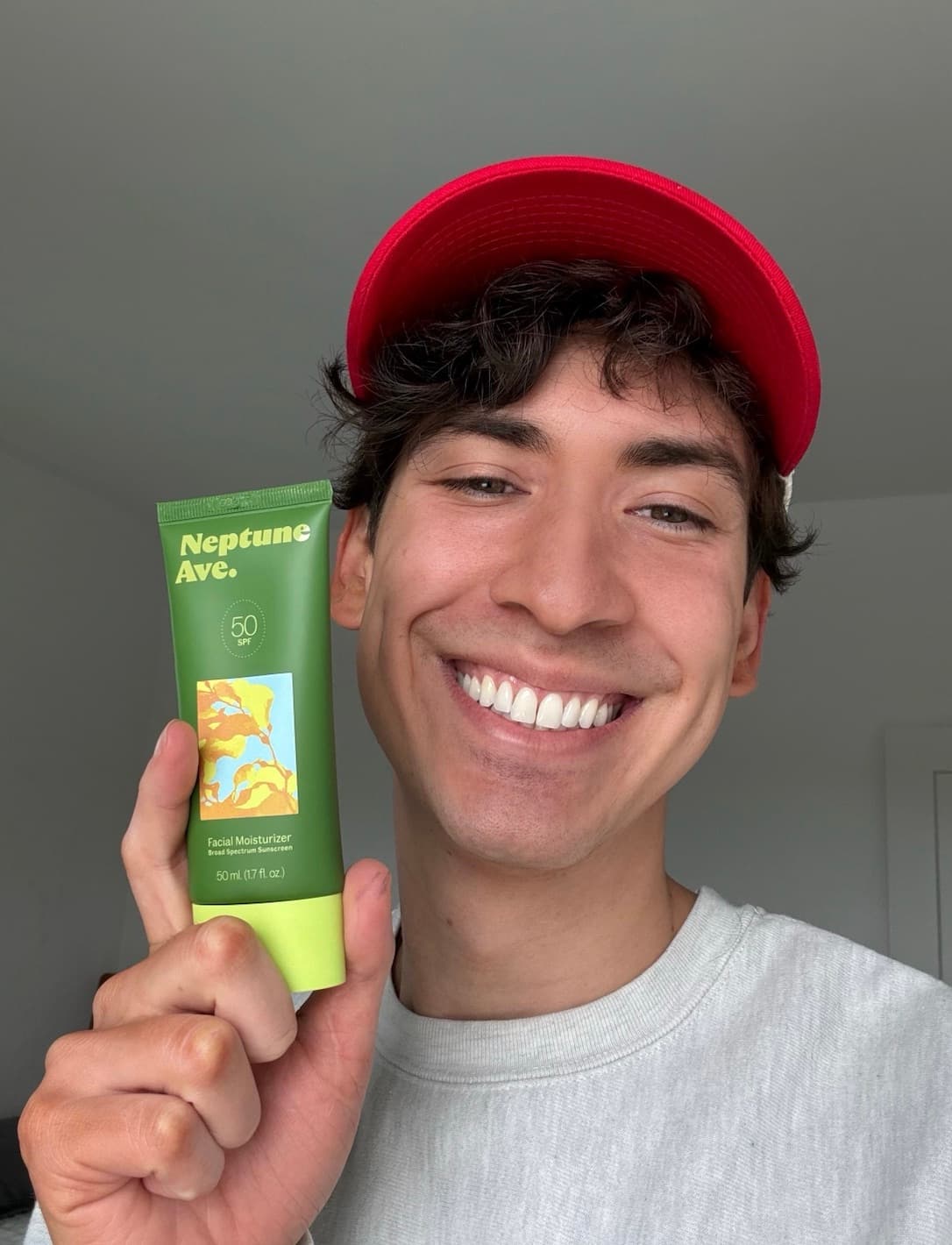 Josh, founder of Neptune Ave., holding High Dive Barrier Repair Sunscreen